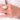 Hand wearing a vintage opal and diamond yellow gold cocktail ring, featuring a pear-shaped opal surrounded by a diamond halo.