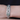 Statement Art Deco bracelet adorned with diamonds and emerald accents in a geometric platinum setting, worn on wrist for a bold vintage look